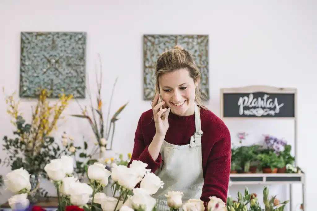 florist working in her shop with a smile on her face