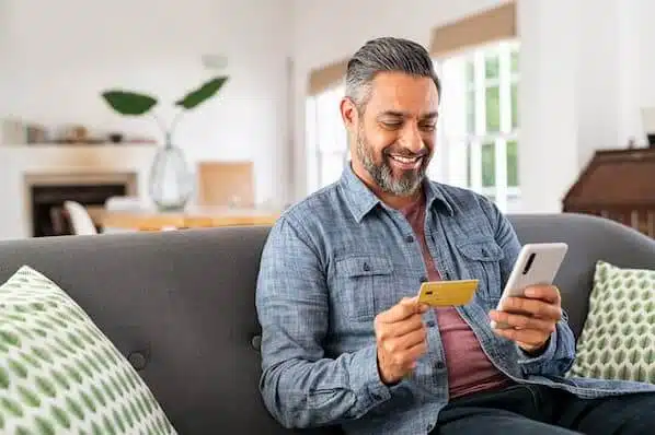 happy man making an online payment via a website