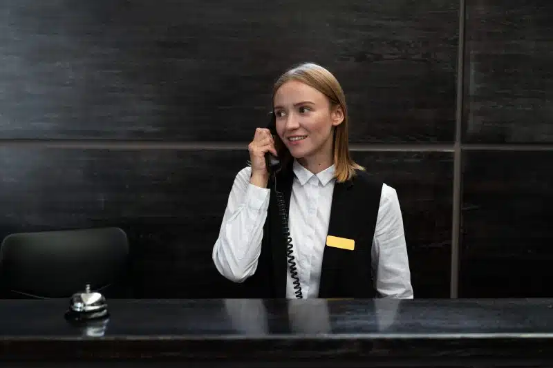 pretty woman at front desk with card machine for hotels