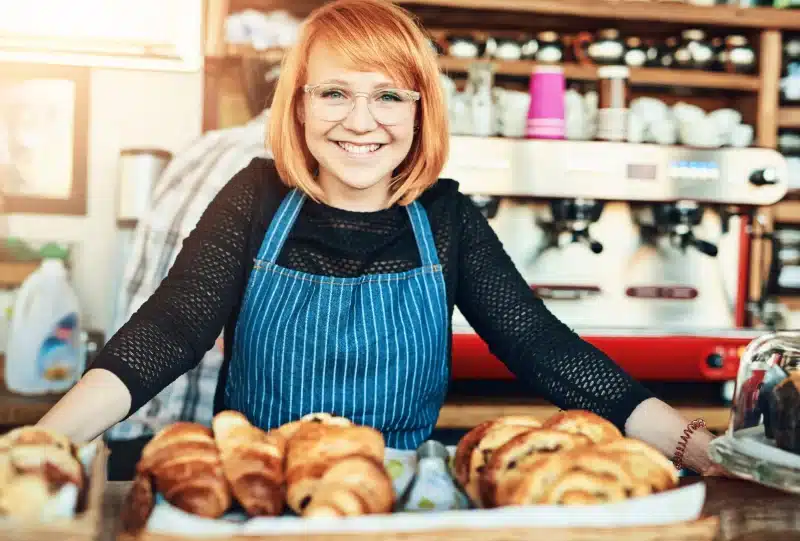 A Happy business Owner and her Card Machine for pubs and restaurants
