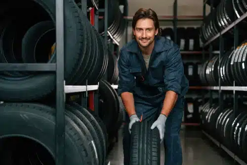 Mechanic rolling a tyre