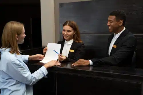 hotel worker taking card machine payment at reception