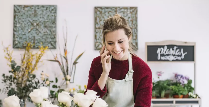 florist working in her shop with a smile on her face