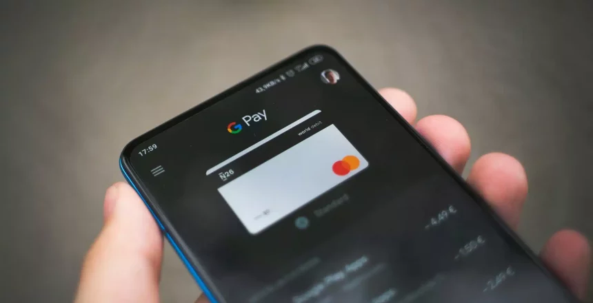 phone screen showing a person taking a payment with their device