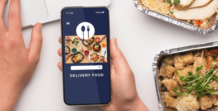Hand holding a smartphone with food delivery app open alongside takeaway meal containers.