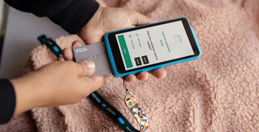 small business owner inserting card into mobile card machine